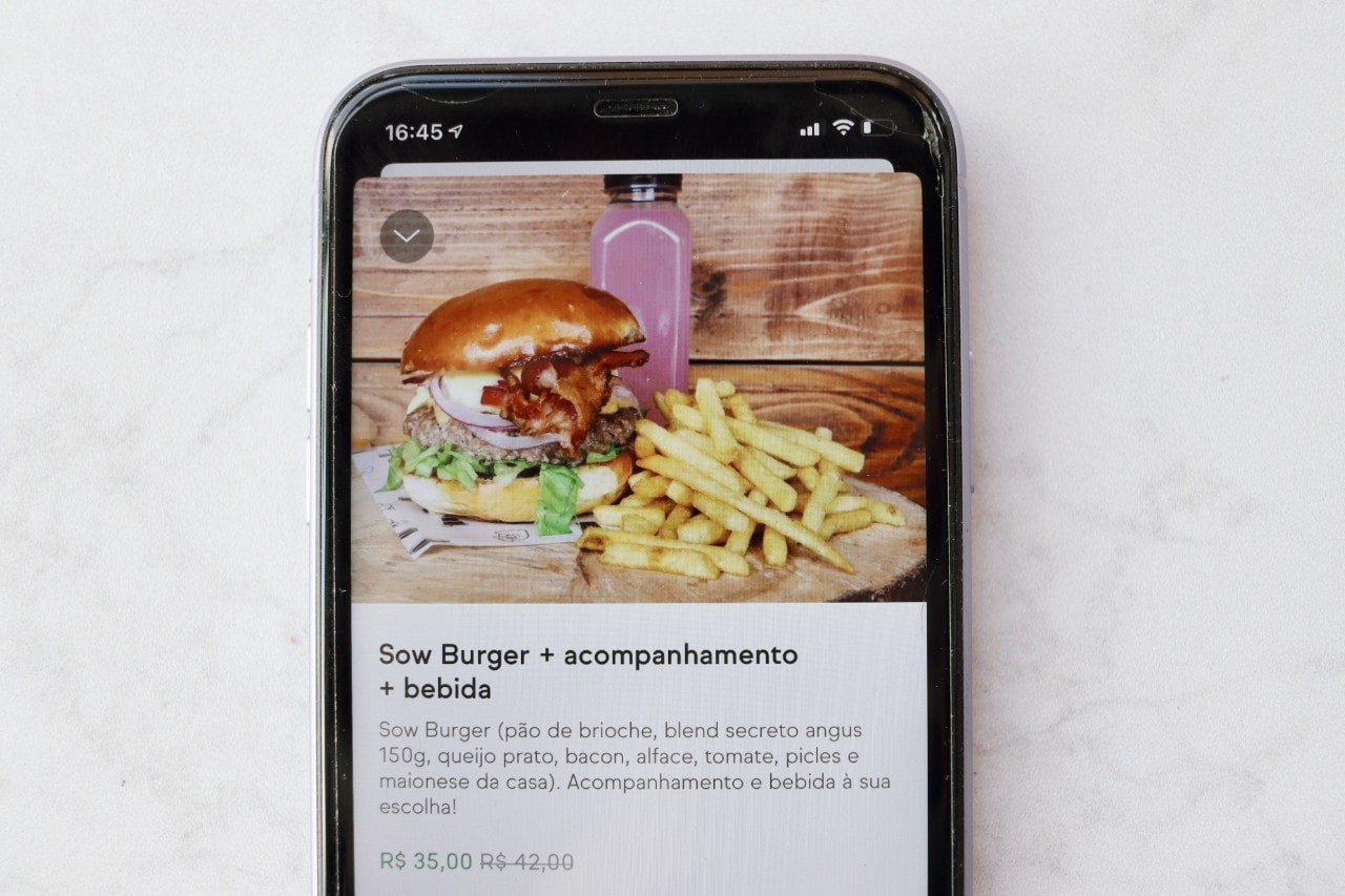 Phone with the delivery app and a burger Phone with the delivery app and a burger