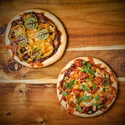 Two flavors bbq pizza on a wooden table Two flavors bbq pizza on a wooden table