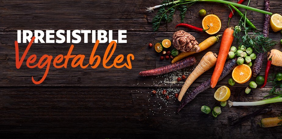 Raw vegetables are laid on a wooden table. The text reads: Irresistible Vegetables. 