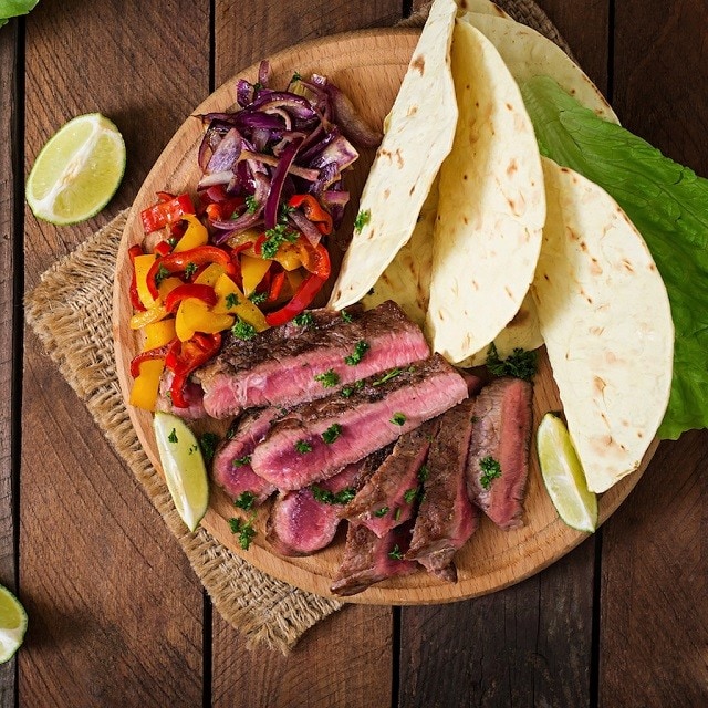 Mexican fajitas for beef steak and grilled vegetables. Top view; Shutterstock ID 390179095; purchase_order: 20210819; job: UFS NAM // Spanish Microsite; client: UFS NAM; other: DMM_Maxim