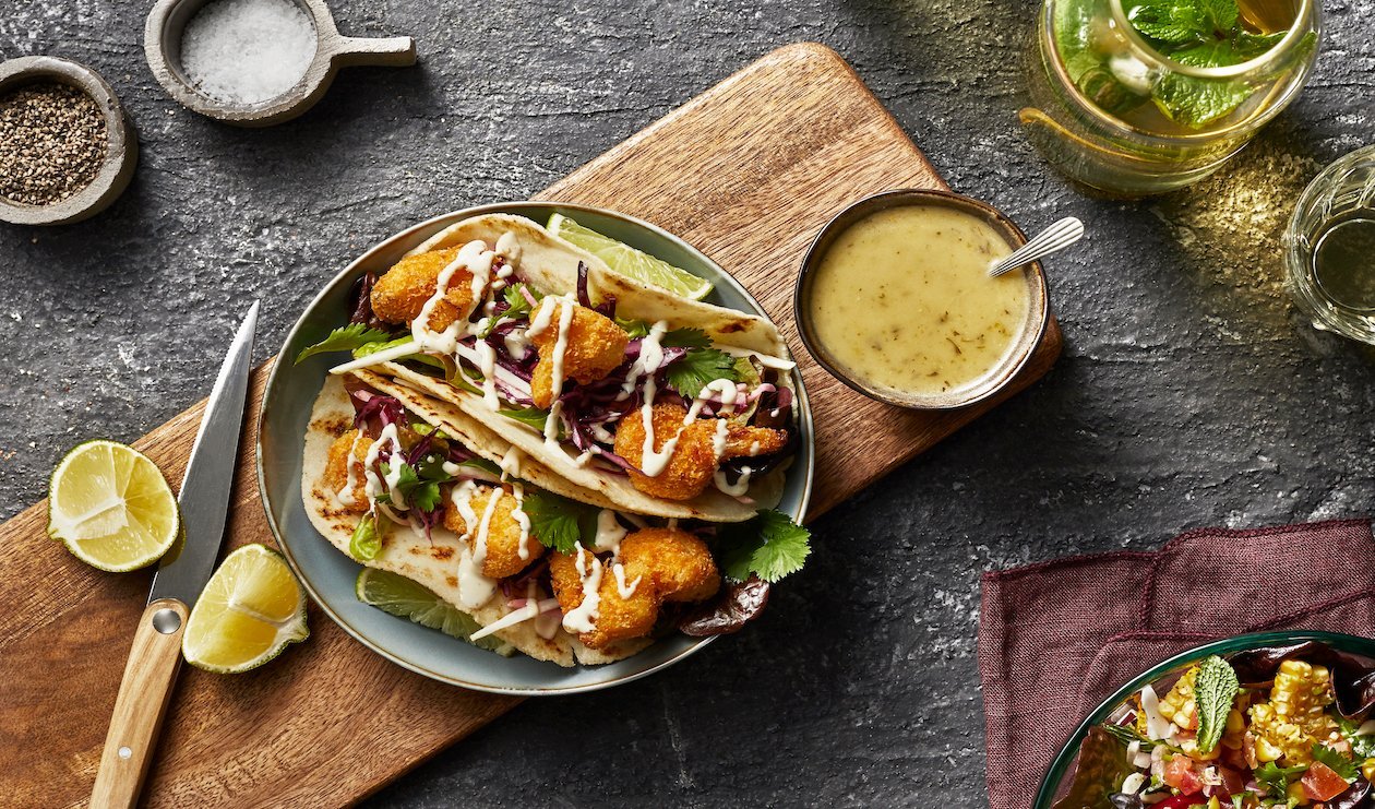 Vegan Fried Cauliflower Tacos with green mango slaw and spicy hatch chile drizzle